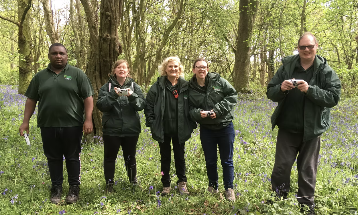a group of volunteers surrounded by trees